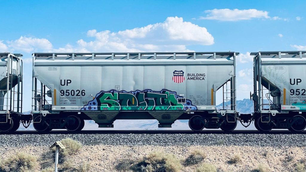 A train covered in vibrant graffiti art, showcasing urban creativity and expression.